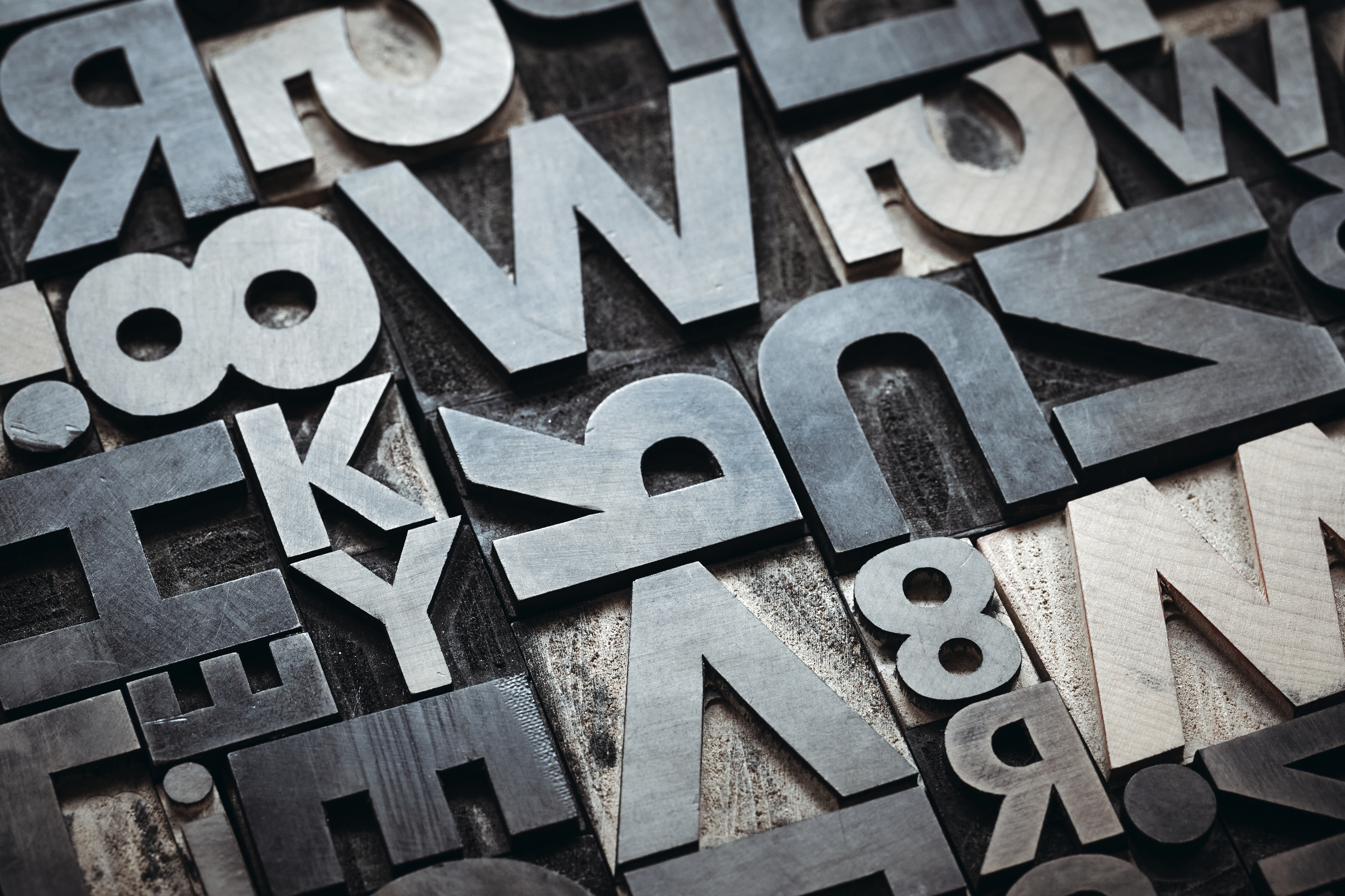 Metal letterpress type arranged in a printing chase — the content that AI cites is set with intent